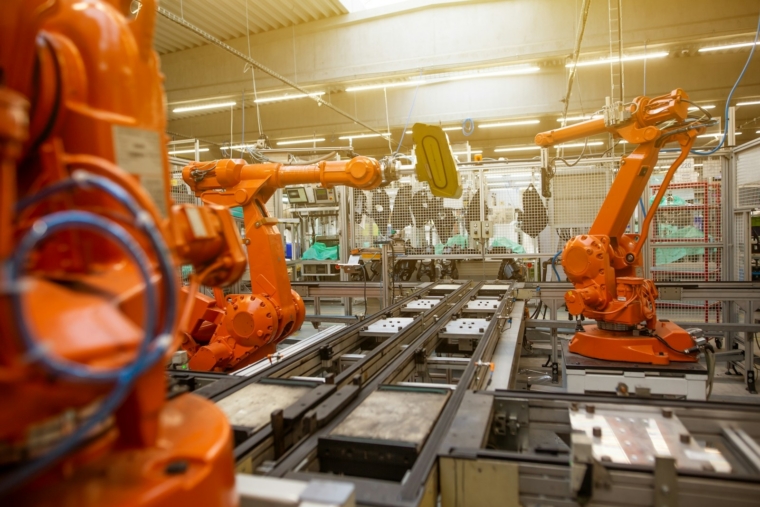 AI training for a manufacturing company in Malaysia on a modern factory floor with automation machinery