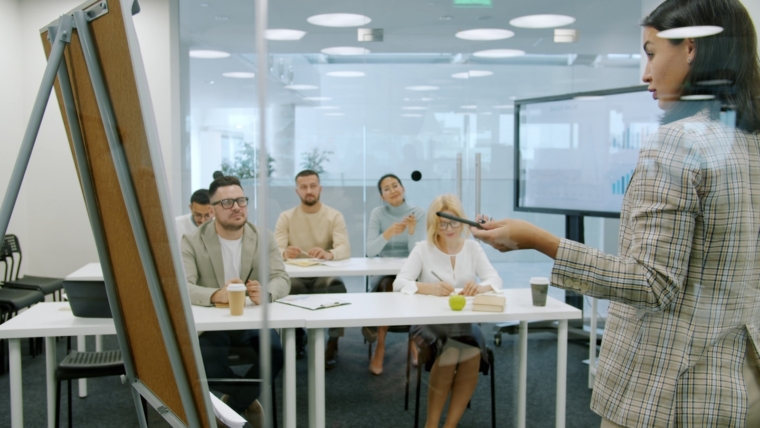 Trainer delivering a corporate AI course to a company team in a Malaysian office workshop