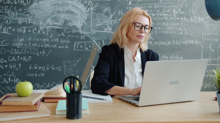 Malaysian teacher using AI on a laptop during professional development training