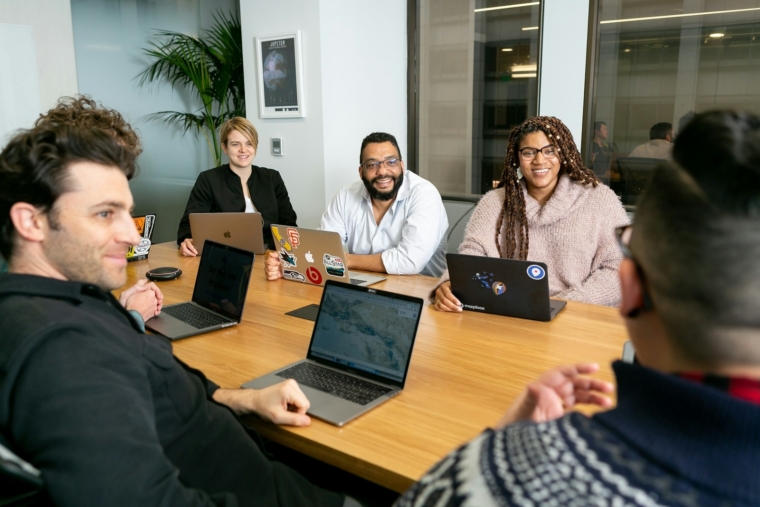 AI training in Bahasa Melayu Malaysia: staff on laptops listening to a trainer during a workshop