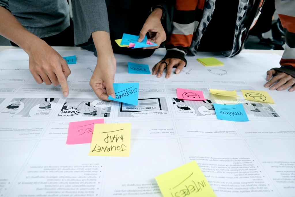 AI training needs analysis Malaysia: team collaborating with sticky notes to map skills and use cases