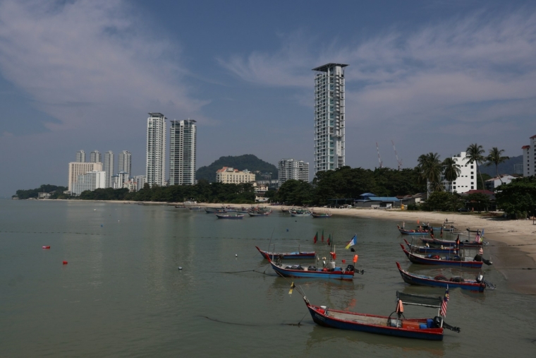Corporate AI training on the East Coast of Malaysia: fishing boats anchored near a sandy beach