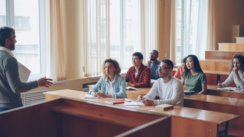 University lecturer teaching students in a lecture hall, illustrating AI training for university lecturers in Malaysia