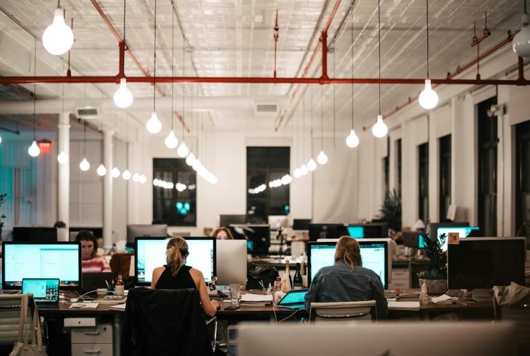 Malaysian business team using AI automation on office computers
