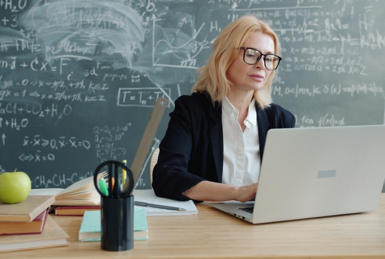 Malaysian teacher using AI on a laptop during professional development training