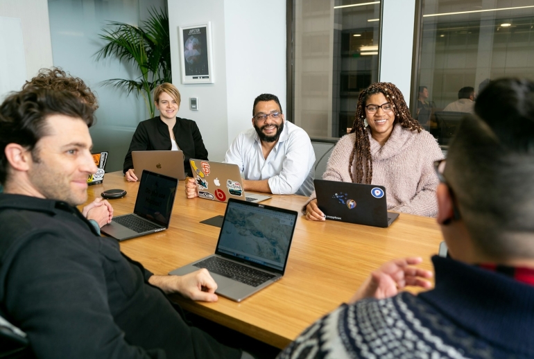 AI training in Bahasa Melayu Malaysia: staff on laptops listening to a trainer during a workshop