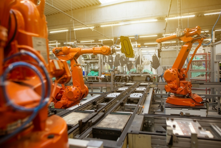AI training for a manufacturing company in Malaysia on a modern factory floor with automation machinery