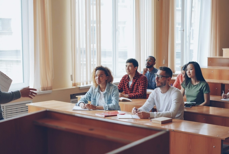 University lecturer teaching students in a lecture hall, illustrating AI training for university lecturers in Malaysia