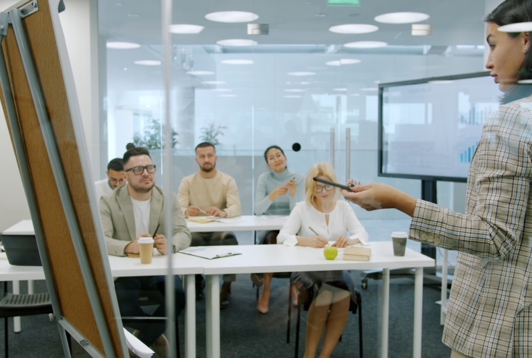Trainer delivering a corporate AI course to a company team in a Malaysian office workshop