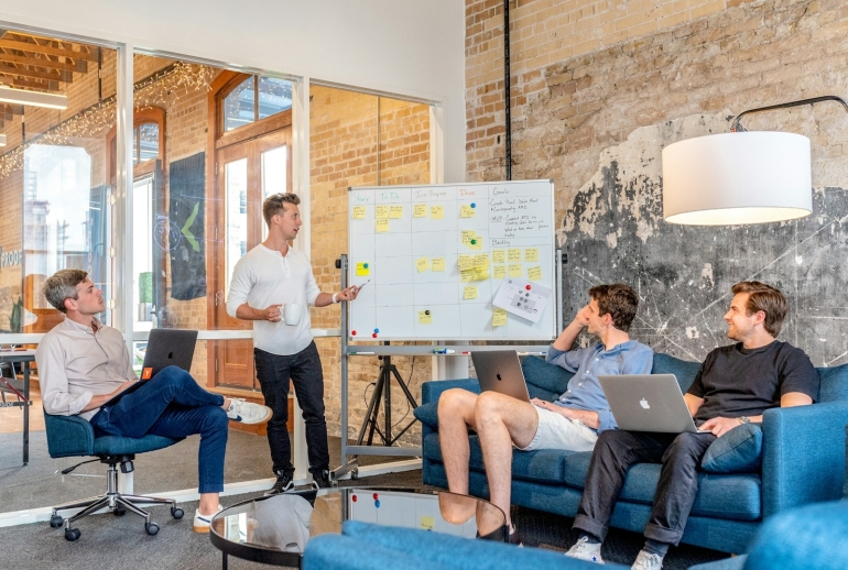 Business team planning a generative AI adoption roadmap in a Malaysian office meeting room