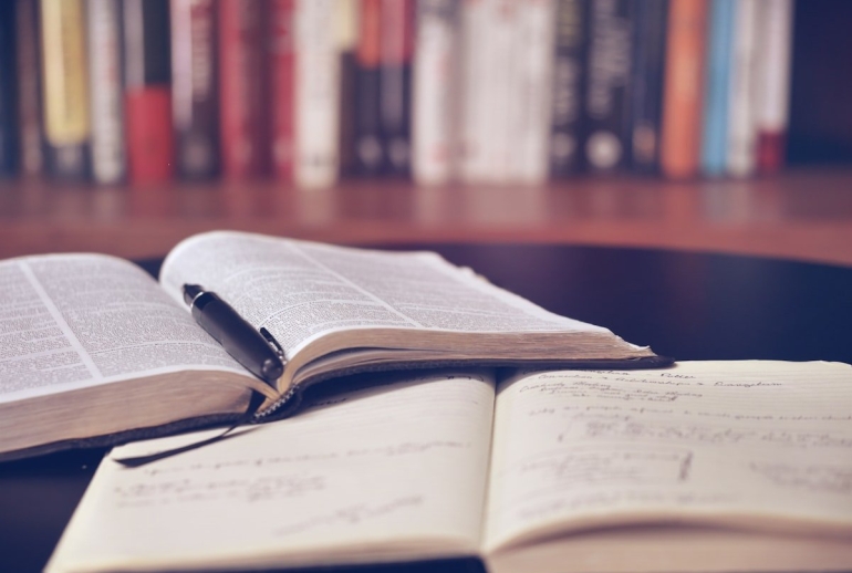 Student writing an AI research proposal for a Malaysian university postgraduate programme